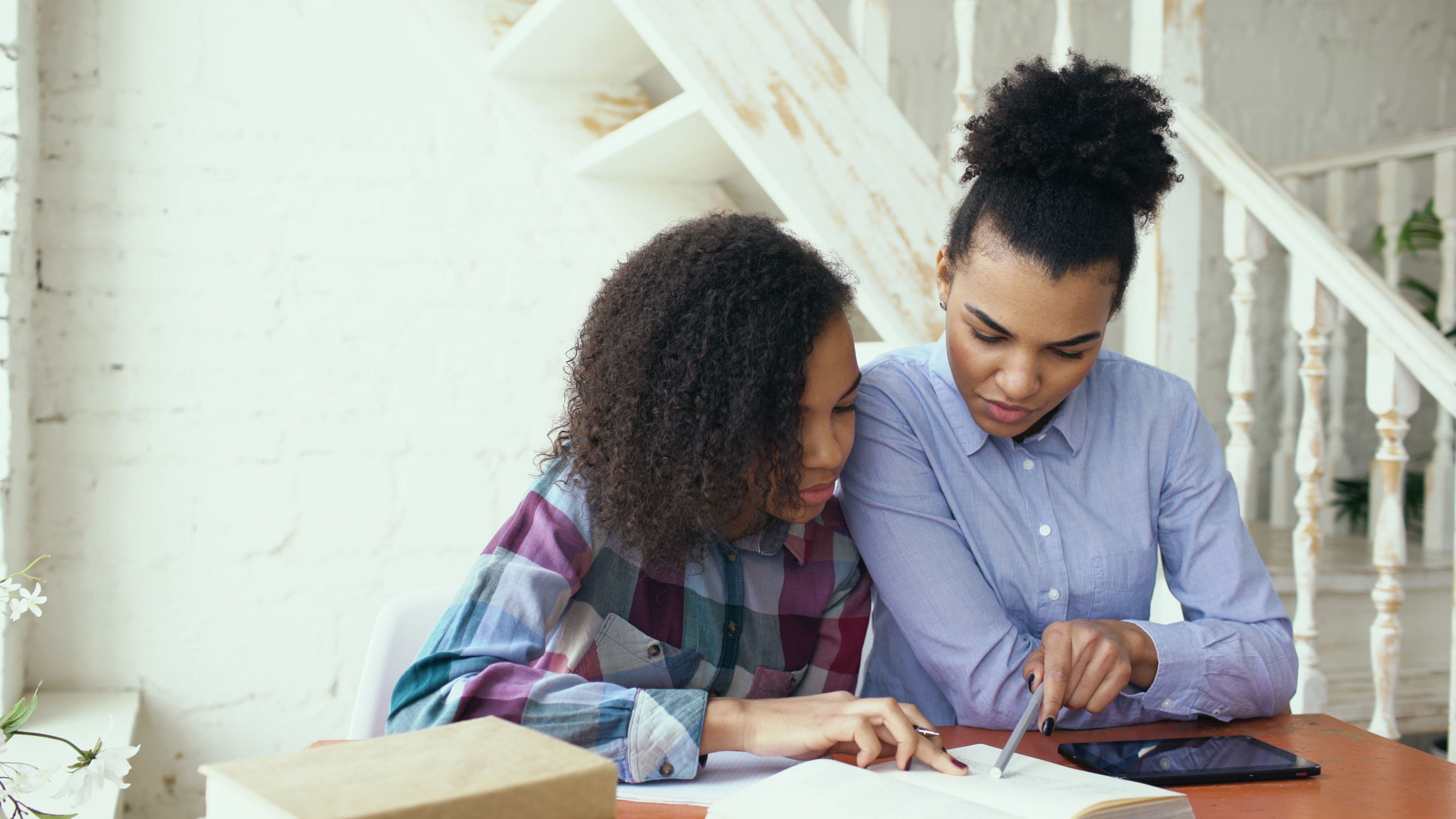 Two people reviewing study materials together