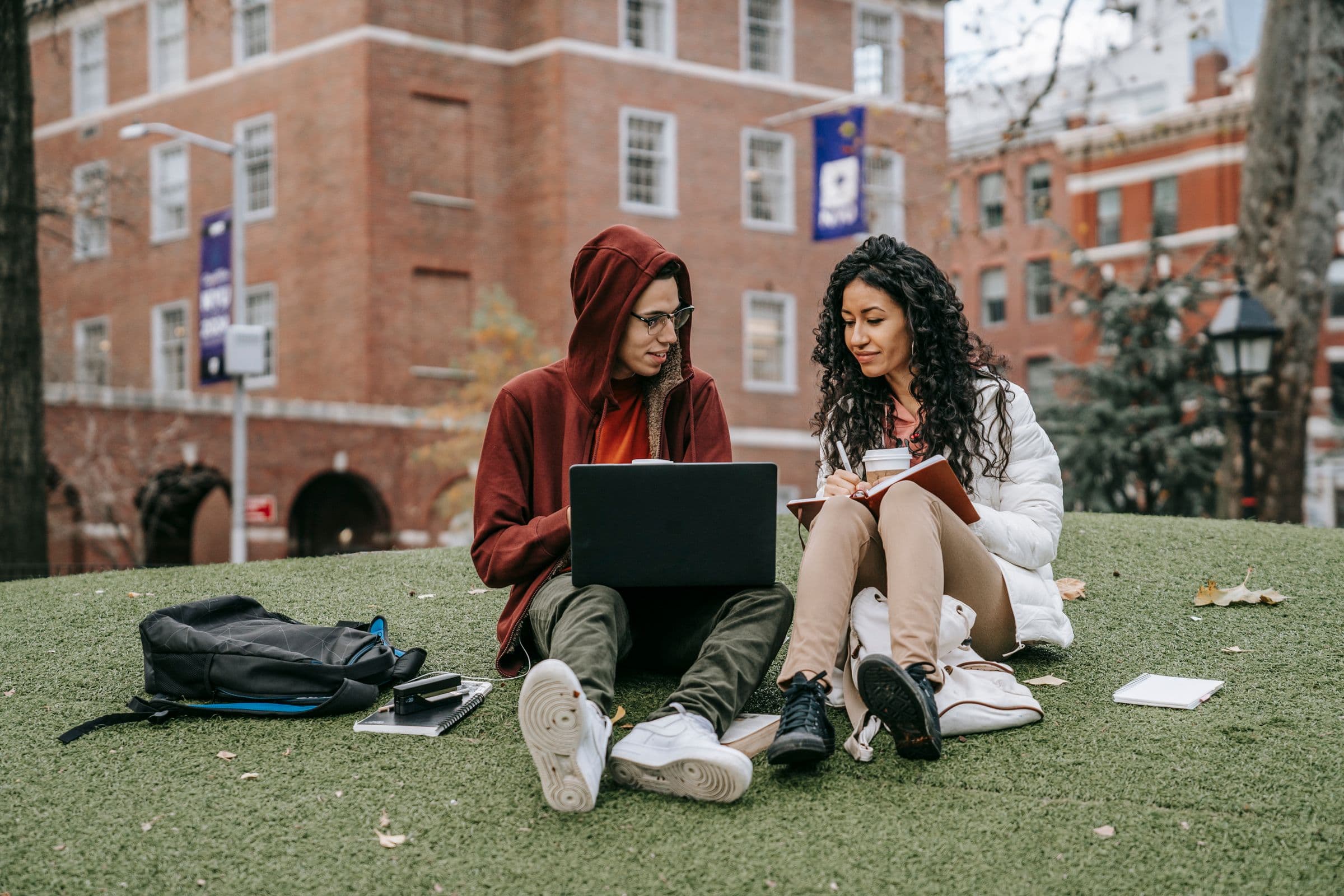 Students discussing university research outdoors